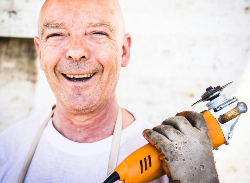A tradesperson holding an angle grinder